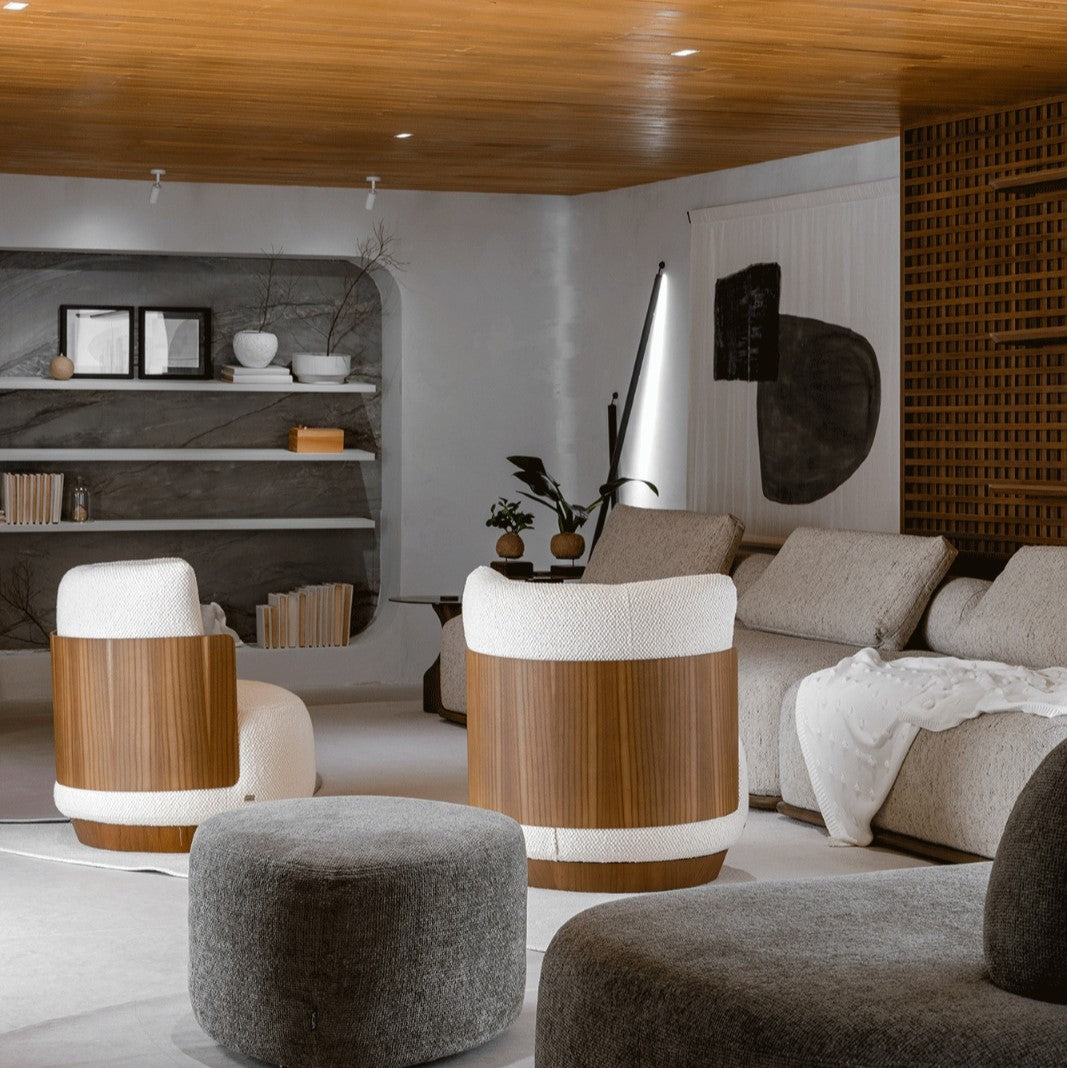 Modern living room with wooden chairs, gray sofa, and decorative items.