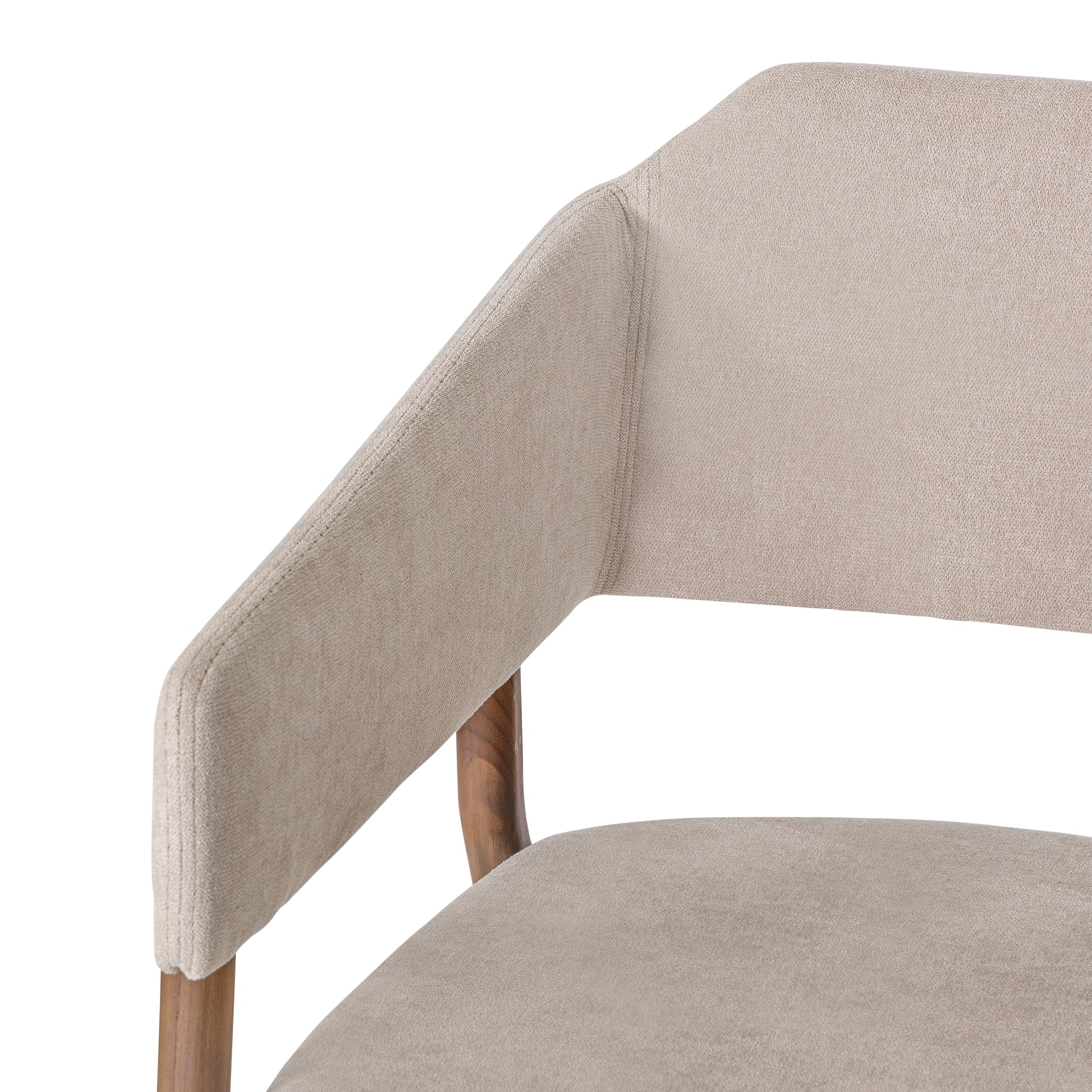 Close-up of a beige upholstered chair with wooden legs on a white background