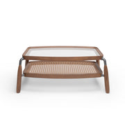 Two-tiered coffee table with wooden top and woven bottom shelf on a white background