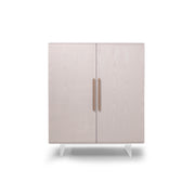 Light gray cabinet with two doors and bronze handles on a white background
