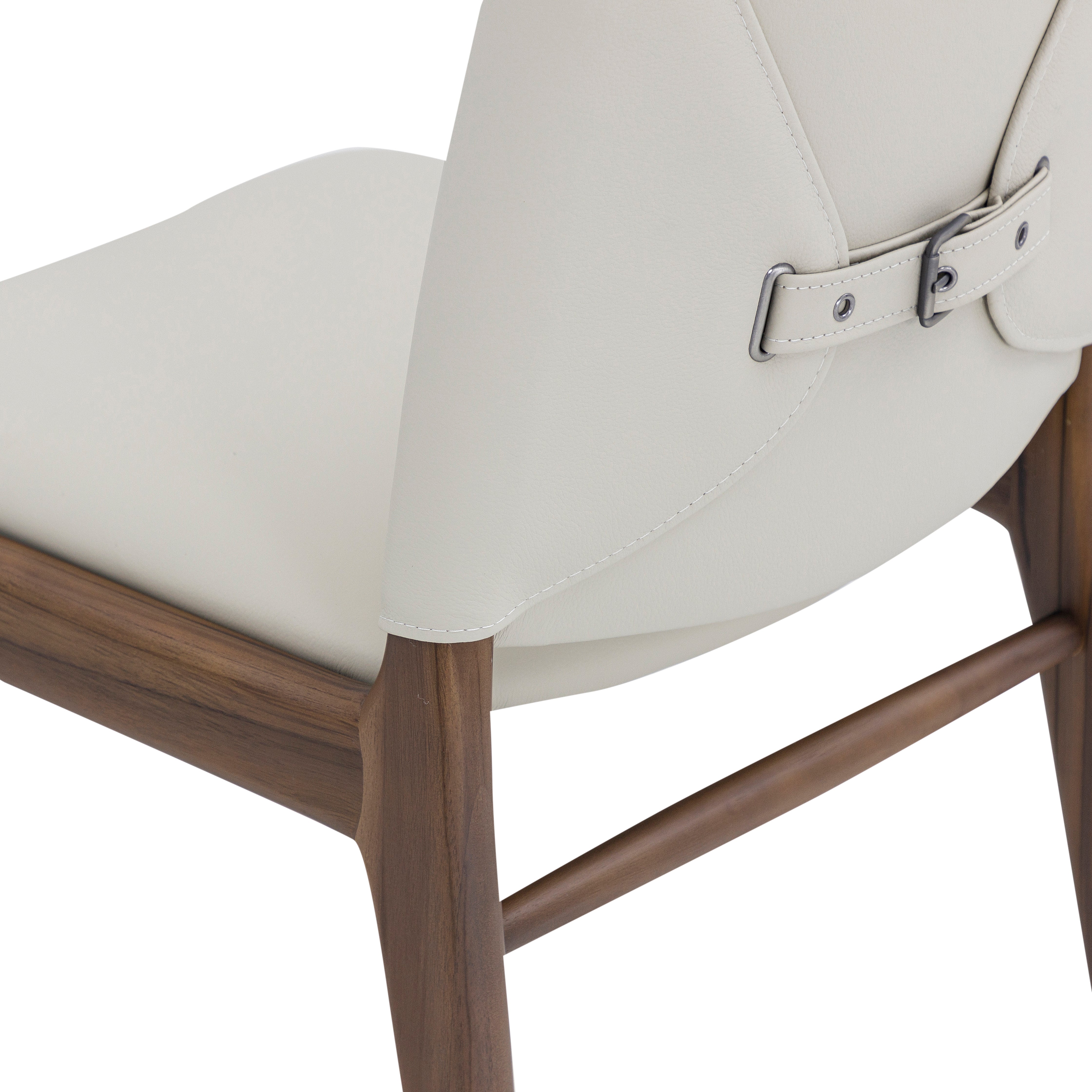 Close-up of a chair with a white cushioned seat and wooden frame on a white background