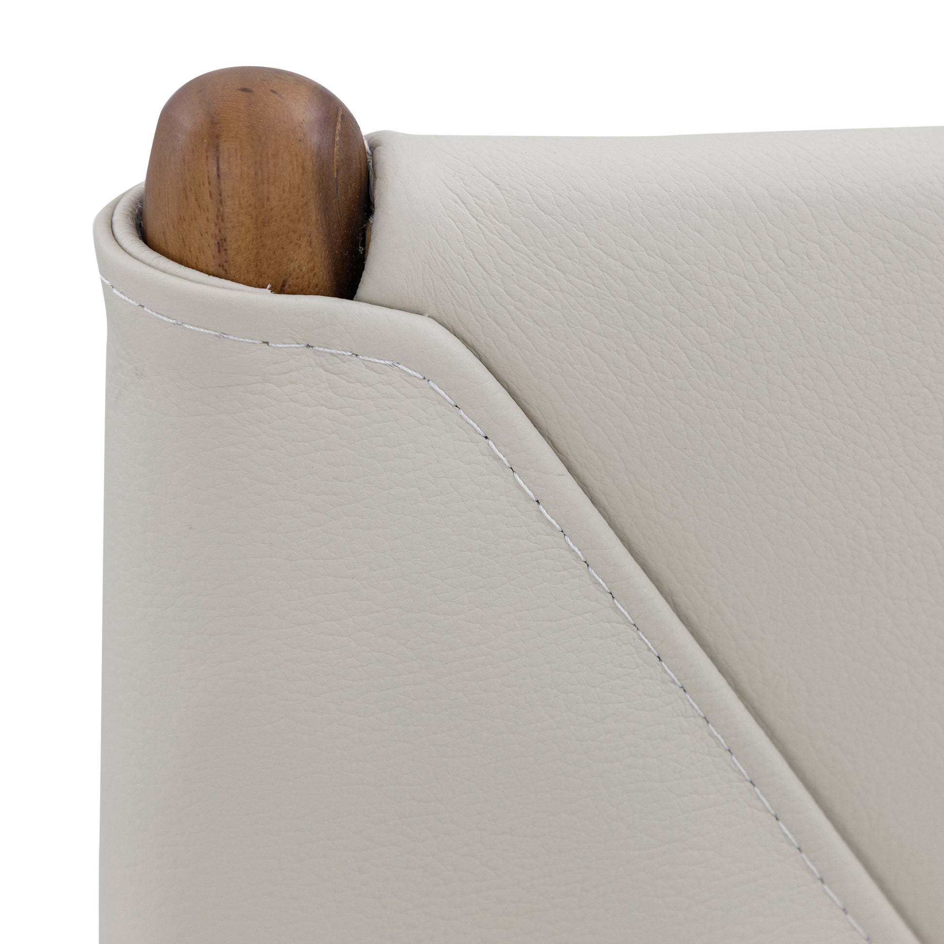 Close-up of a light gray sofa corner with a wooden armrest.