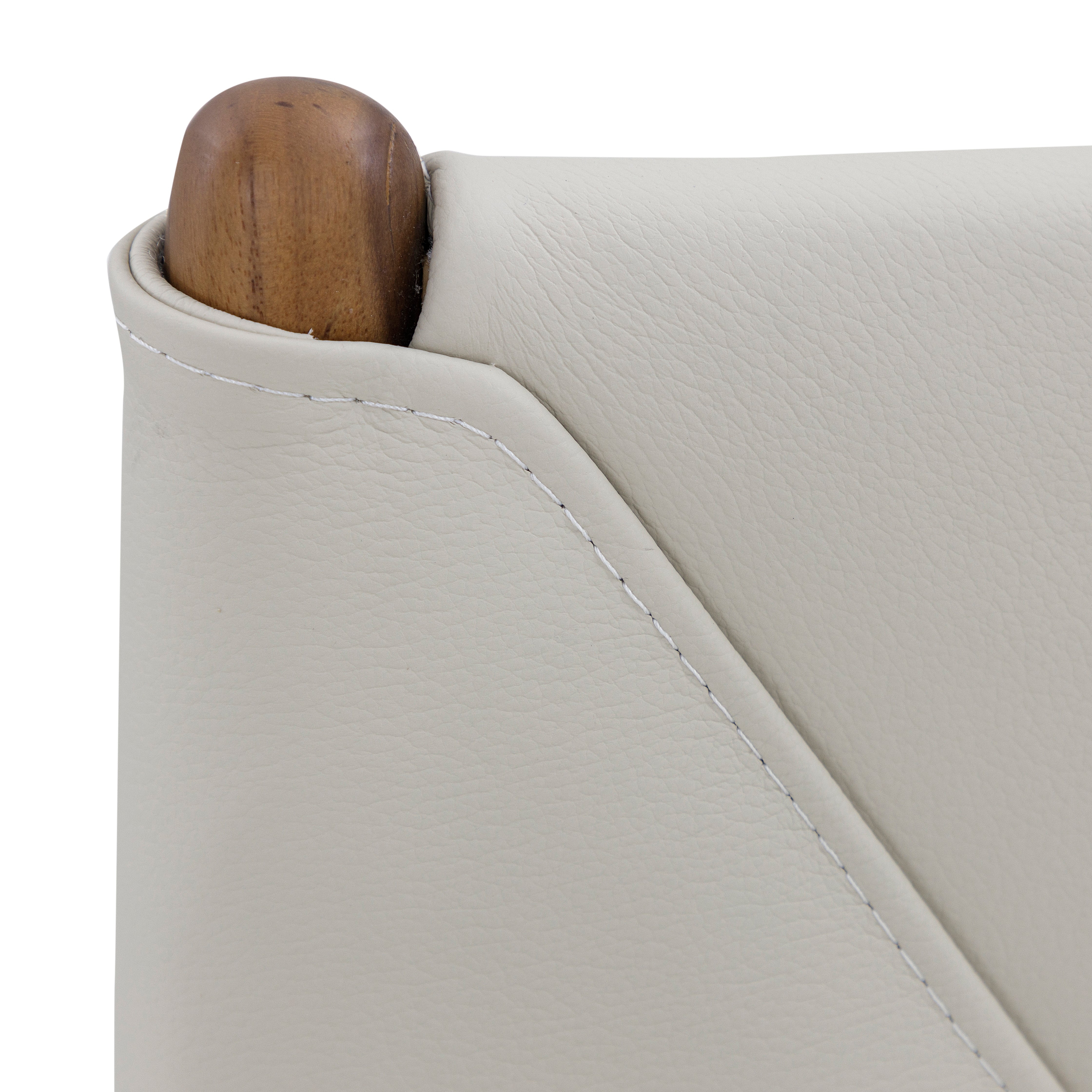 Close-up of a light gray sofa corner with a wooden armrest.