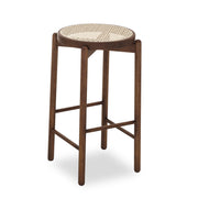 Bar stool with woven seat on a white background