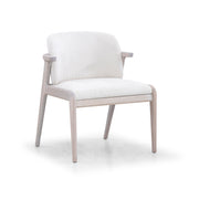 A NOWE dining chair with Dover Oak wooden frame in a light beige color and an ivory fabric cushion on the seat and backrest.
