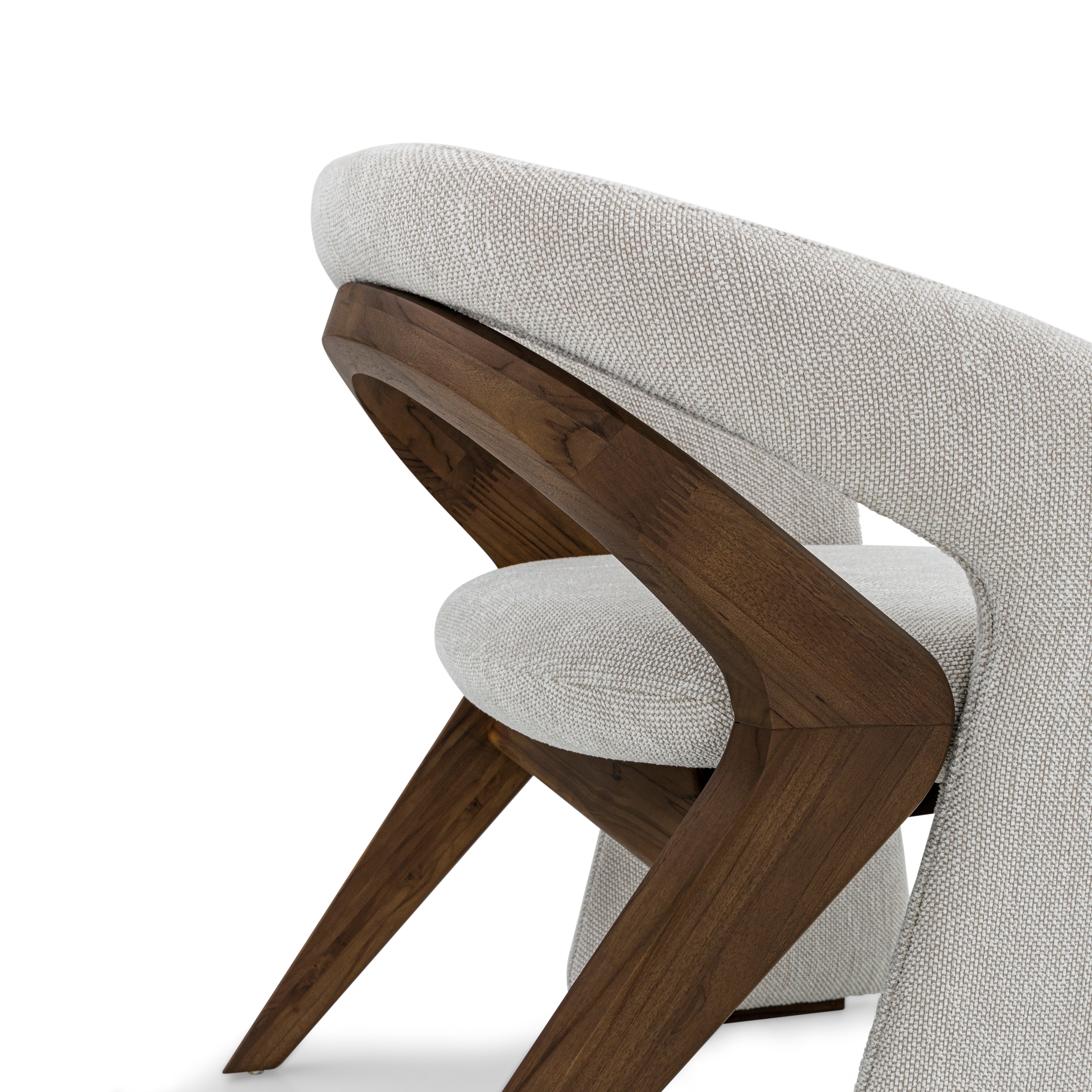 Chair with wooden legs and gray cushioned backrest on a white background