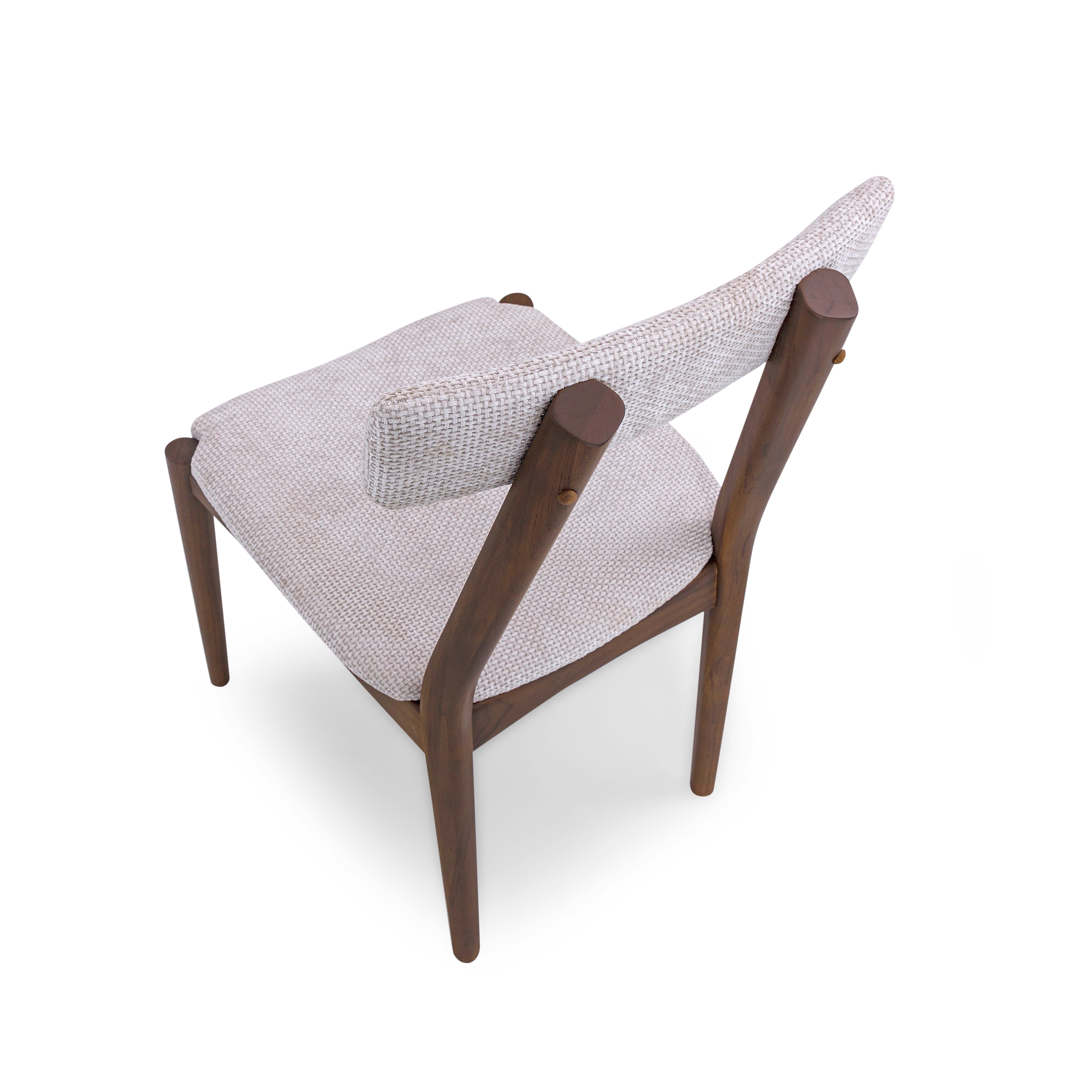 Modern chair with white cushioned seat and backrest on a white background