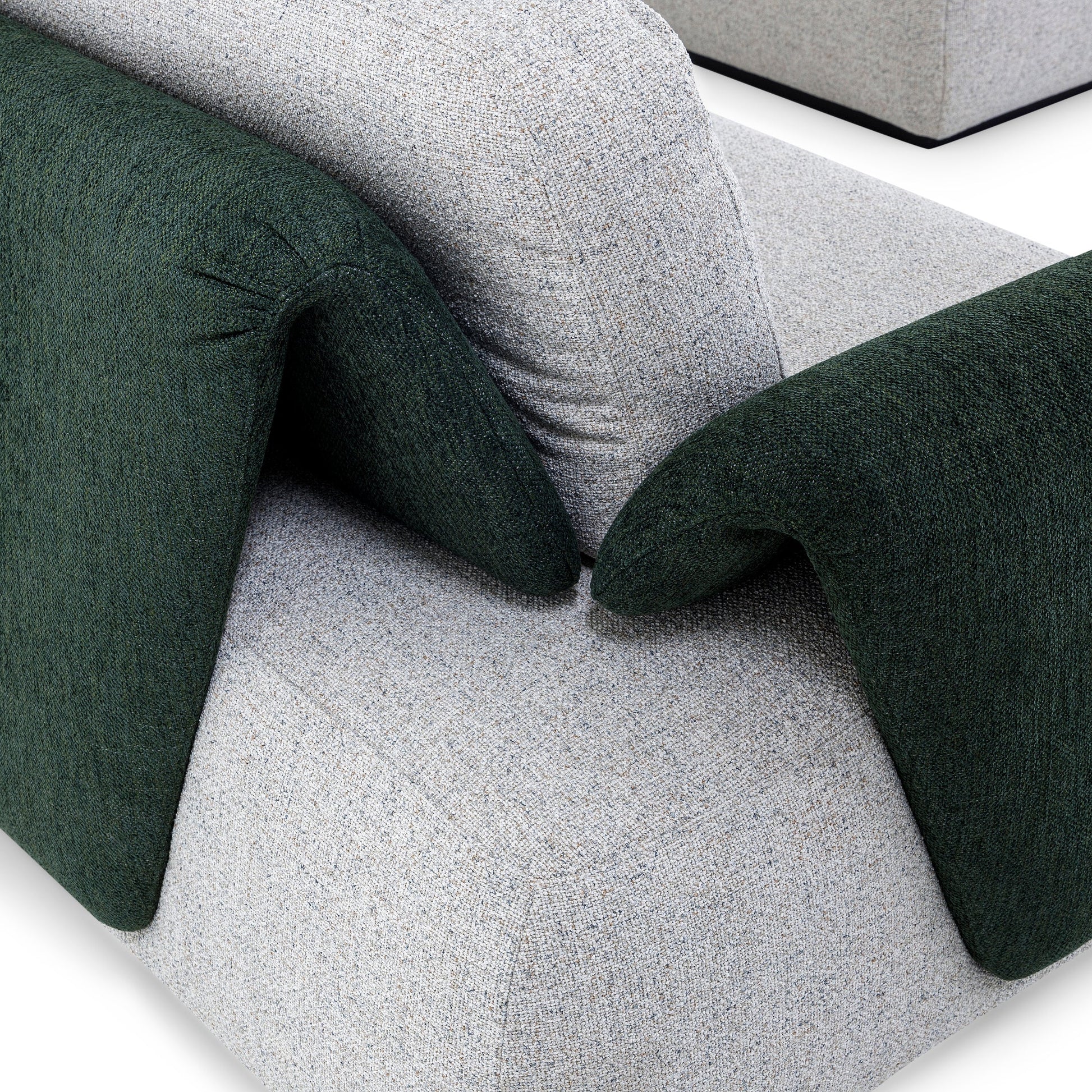 Close-up of a modern sofa with green and gray cushions on a white background