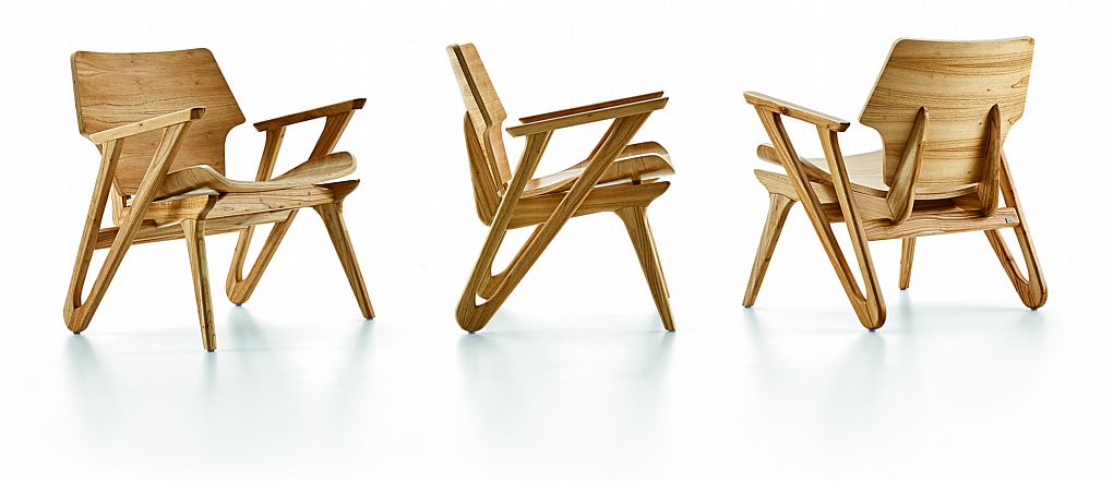 Three wooden chairs arranged in a row on a white background