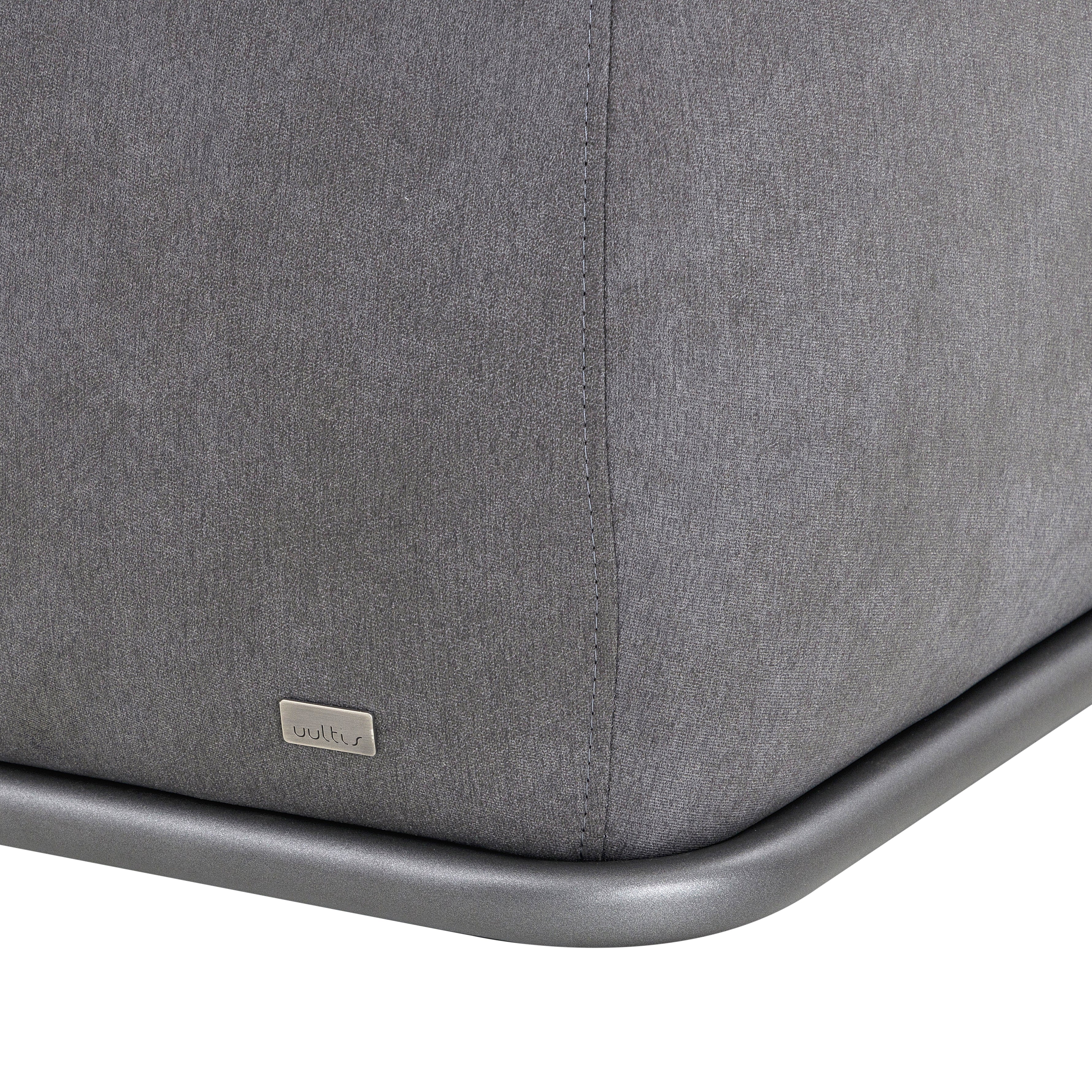 Gray upholstered chair with metal frame on a white background