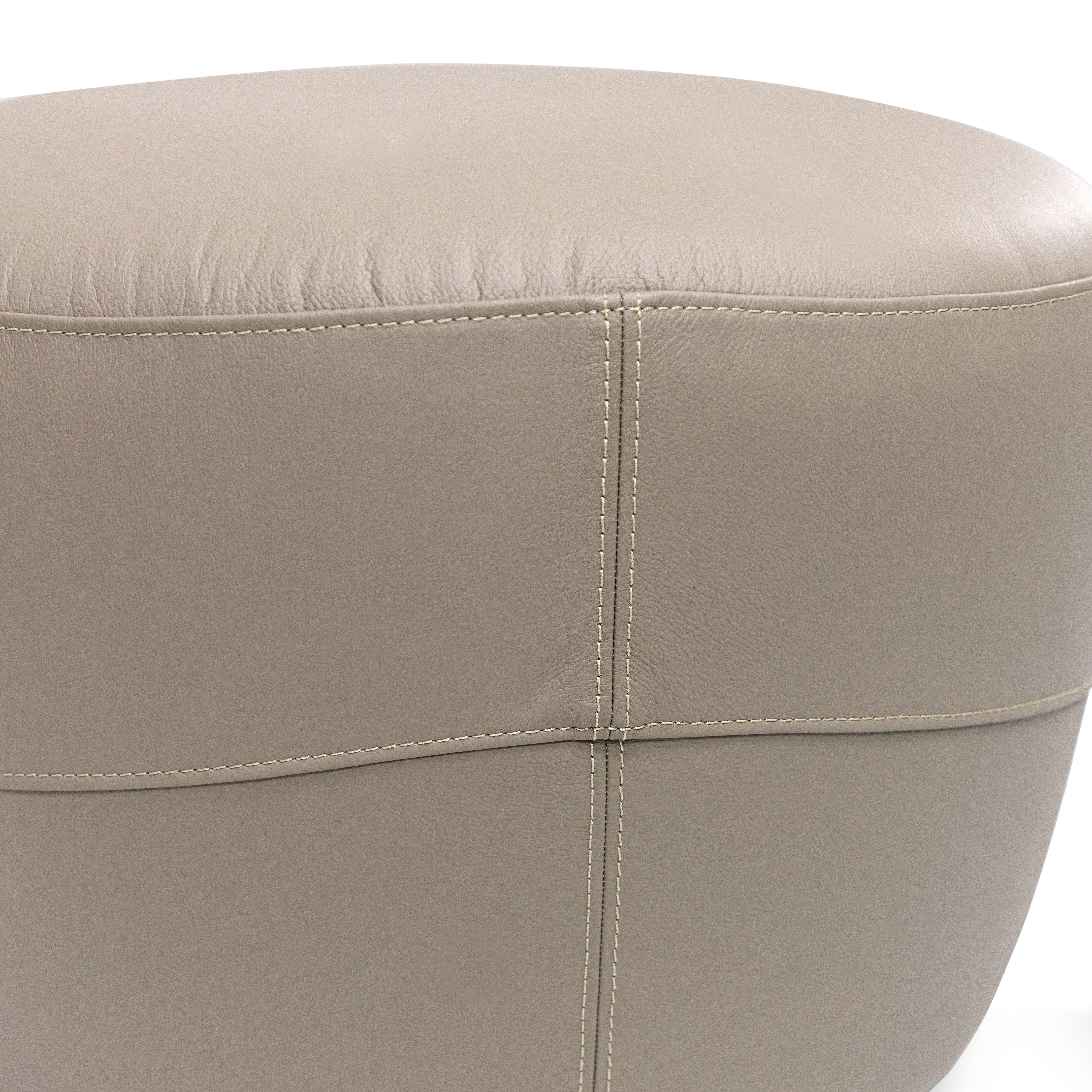 Close-up of a beige leather ottoman on a white background