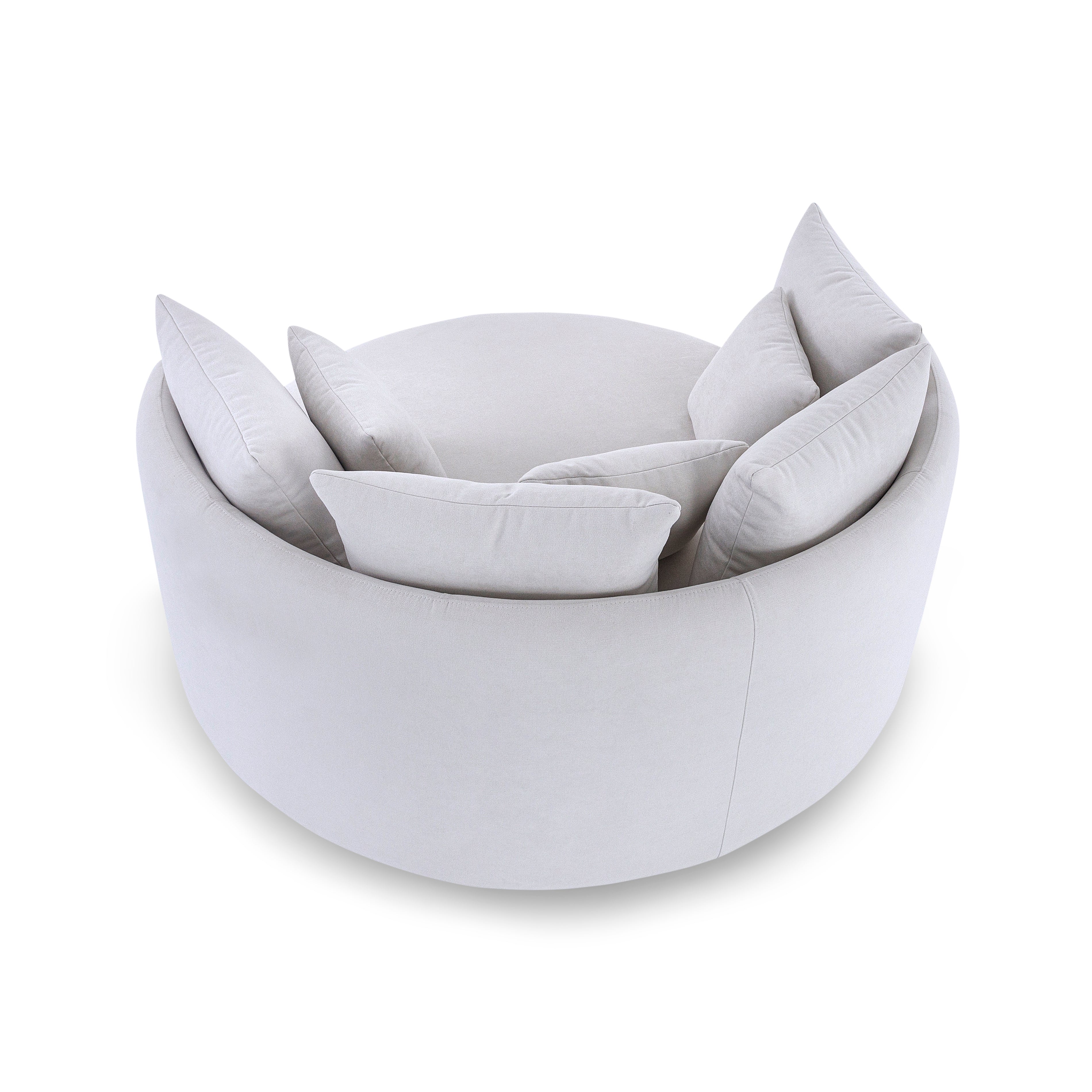 Light gray cushioned chair with multiple cushions on a white background