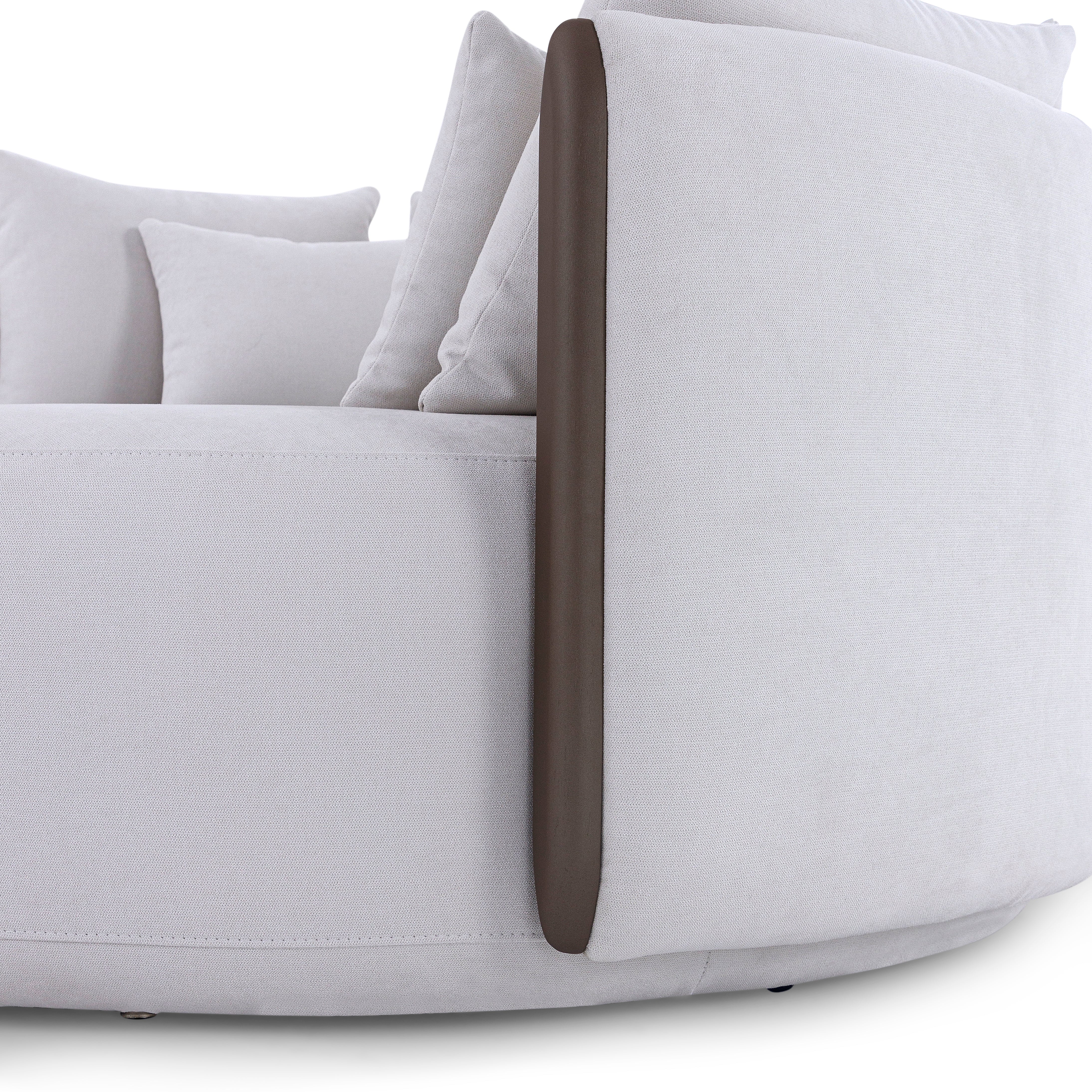 Gray sofa with a brown armrest on a white background