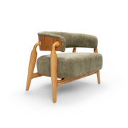 A green upholstered armchair with a wooden frame and a visible brand tag on the side.