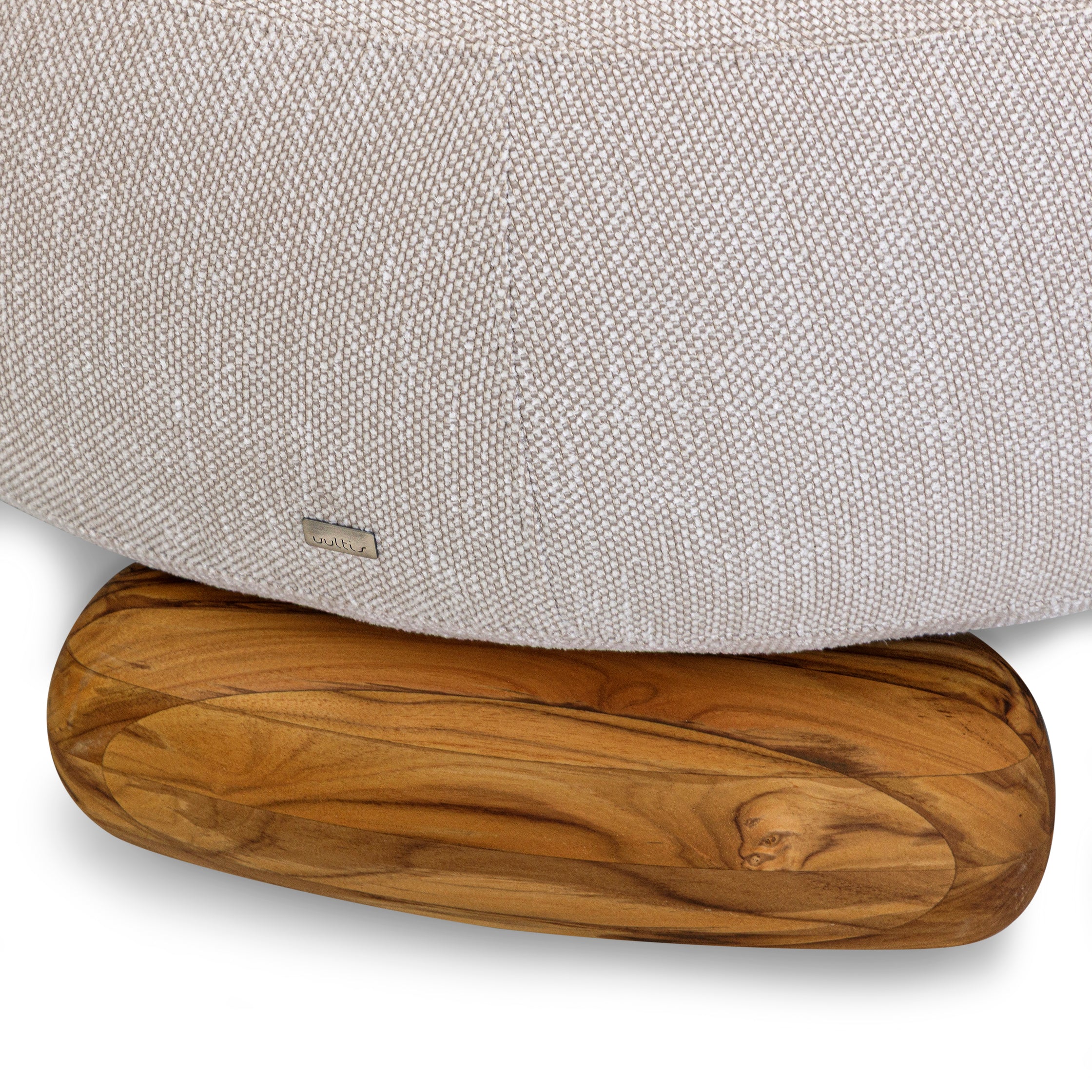 Wooden footstool with a gray upholstered chair in the background
