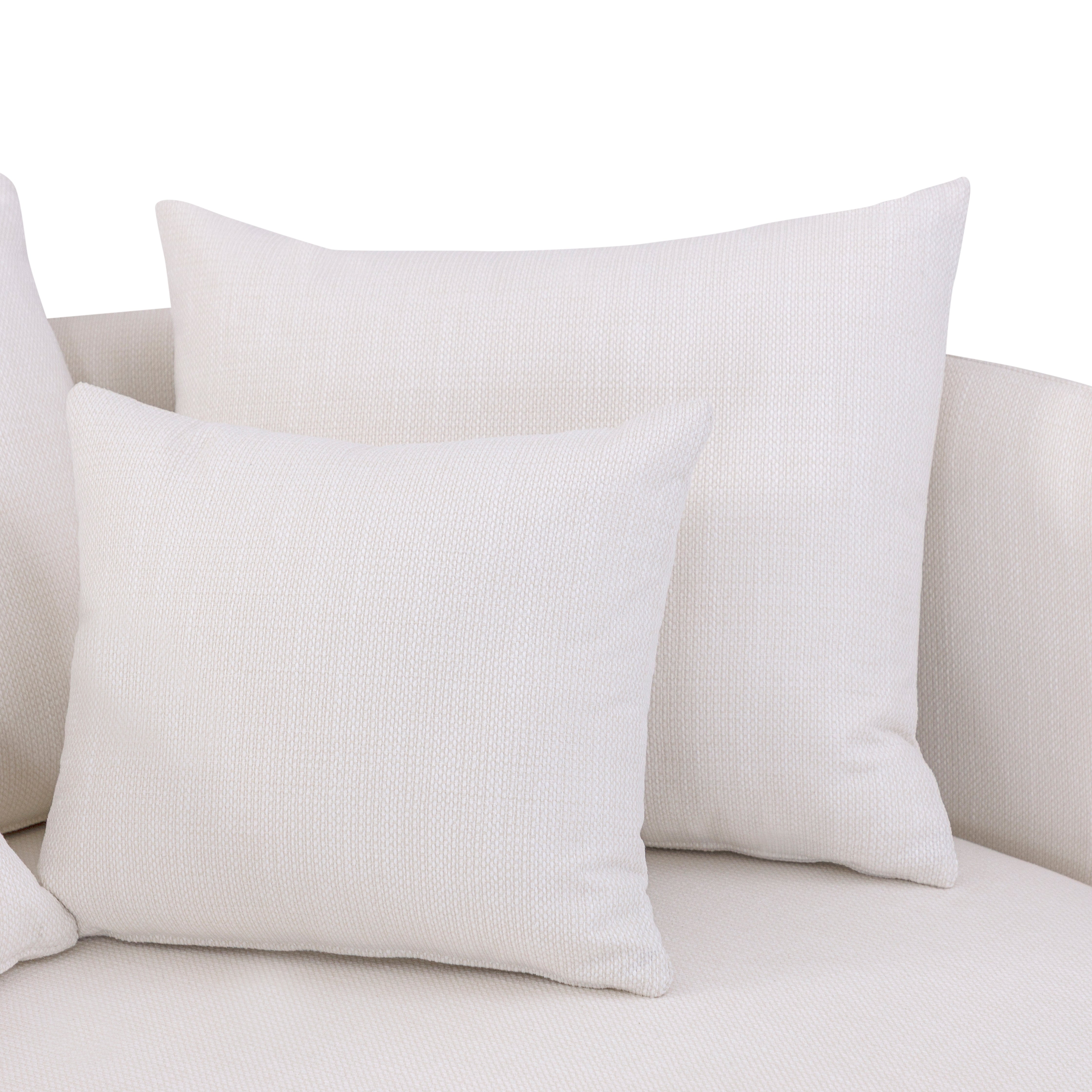 White textured pillows on a light gray sofa against a white background