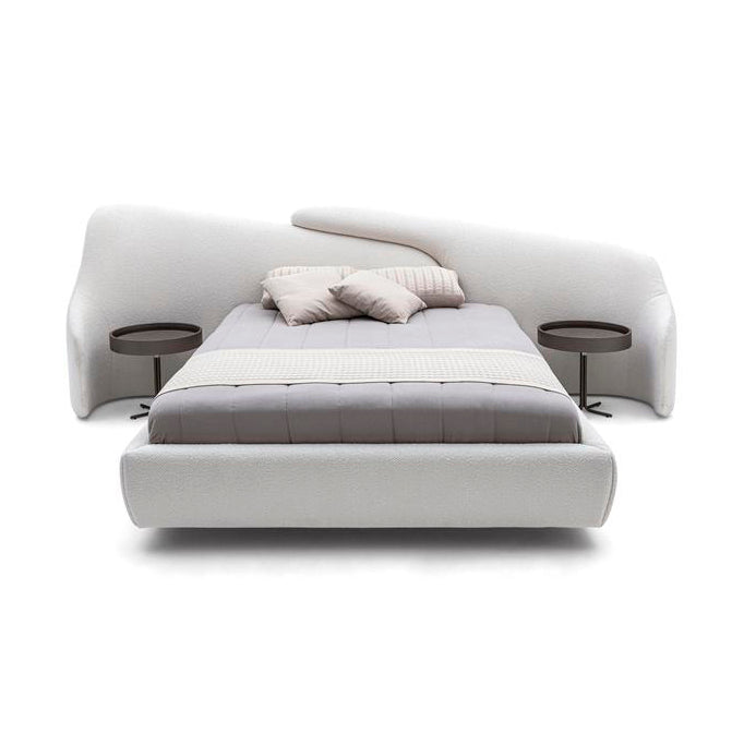 A white bed with a modern design, including built-in bedside tables with lamps.