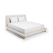 A beige upholstered bed frame with a headboard and wooden legs, accompanied by two white pillows.